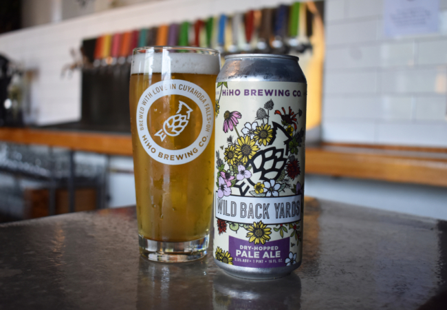 A can of Wild Back Yards beer sits on a counter with a full HiHO Brewing Co. pint glass next to it.