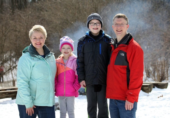 Meghan Doran stands with her family, bundled up in winter coats.