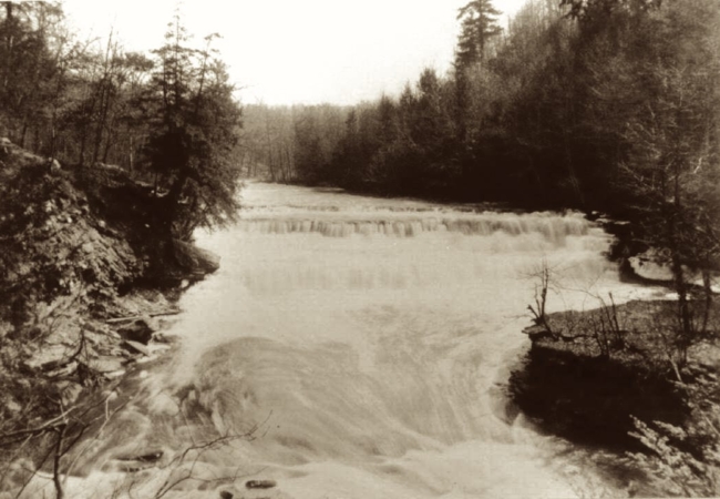 Black and white photo of the Big Falls along the Cuyahoga River.