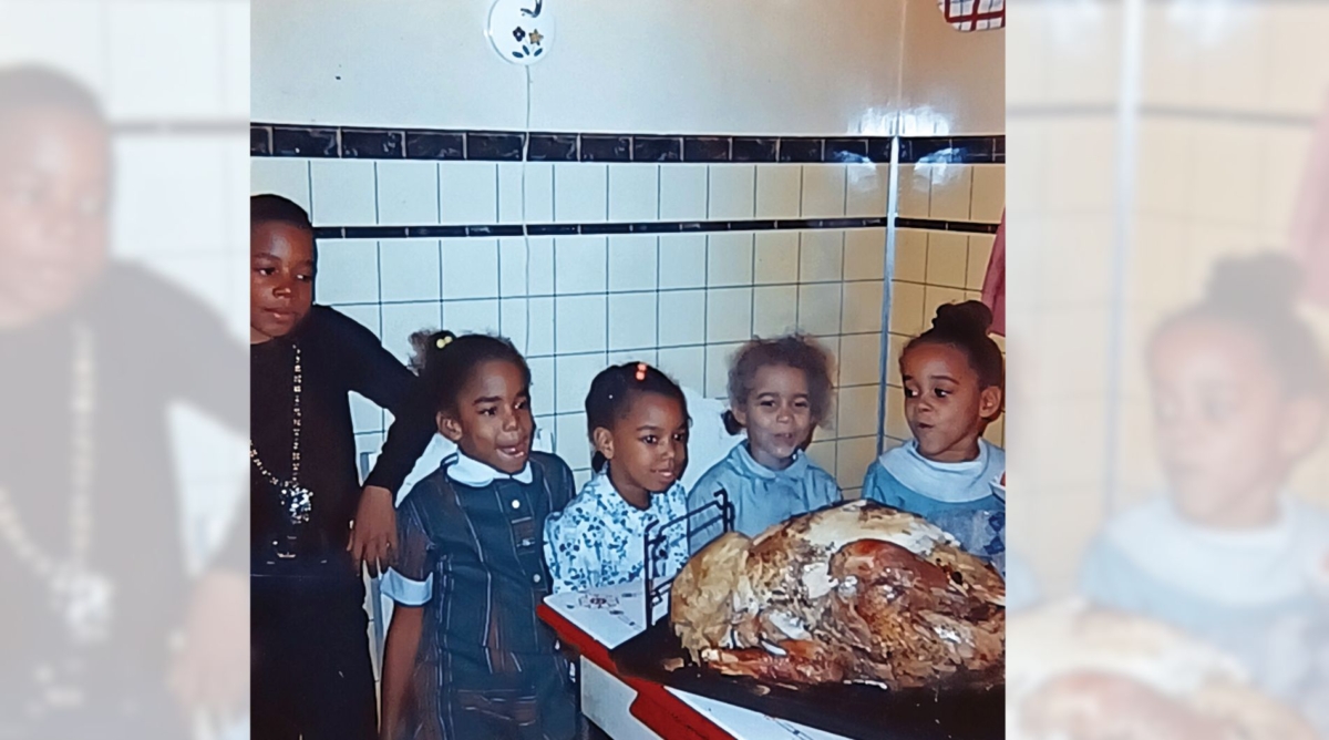 Five of the Johnson grandkids in the kitchen, standing next to a table with a turkey on it