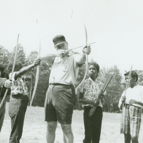 Vintage photo of an archer instructor teaching kids