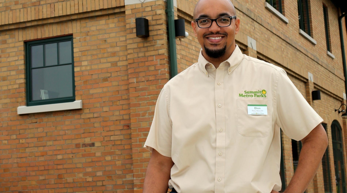 Proud employee standing in front of a building