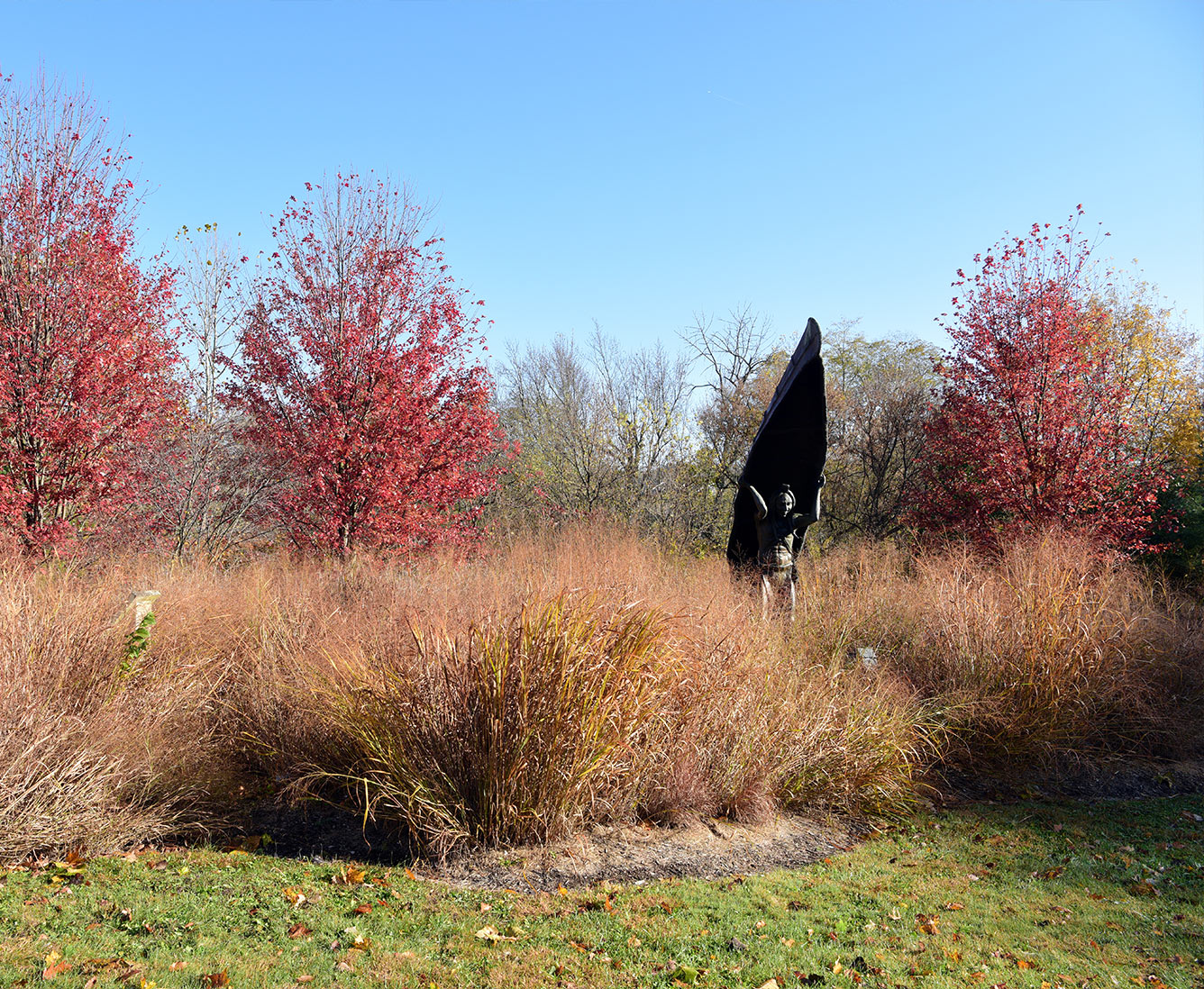 Indian American statue carrying a canoe