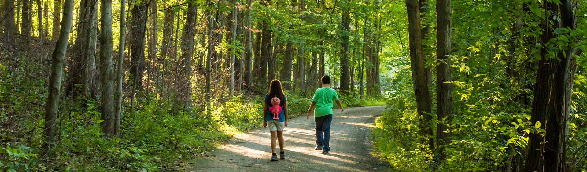 Two kids walking on a trail