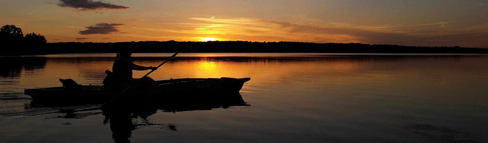 Kayaker on the lake at sunset.